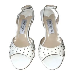 Jimmy Choo patent leather grommet slingback sandals.